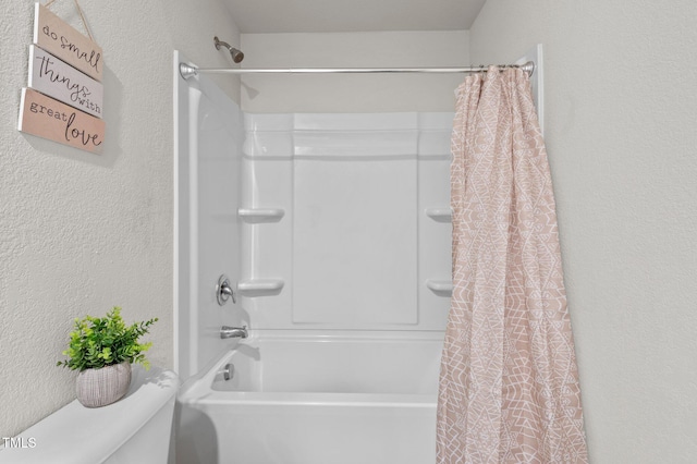 bathroom with shower / bath combo with shower curtain and toilet