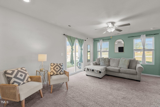 living room with ceiling fan and carpet floors