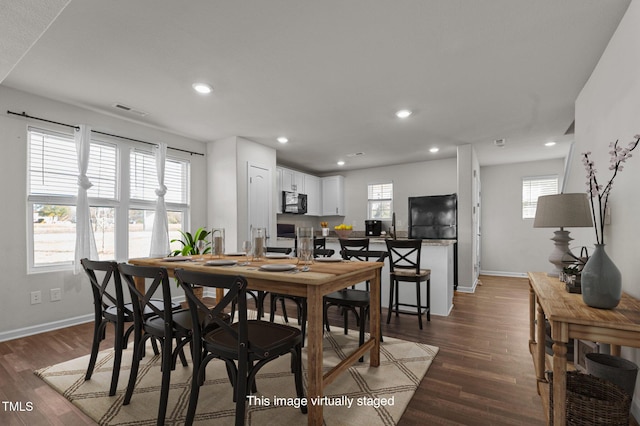 dining area featuring sink and dark hardwood / wood-style floors