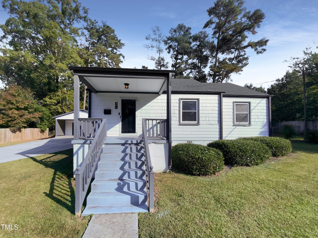 view of front of property with covered porch and a front yard