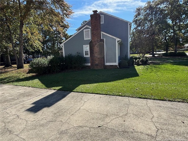 view of home's exterior with a yard