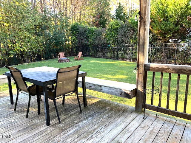 wooden terrace featuring a lawn