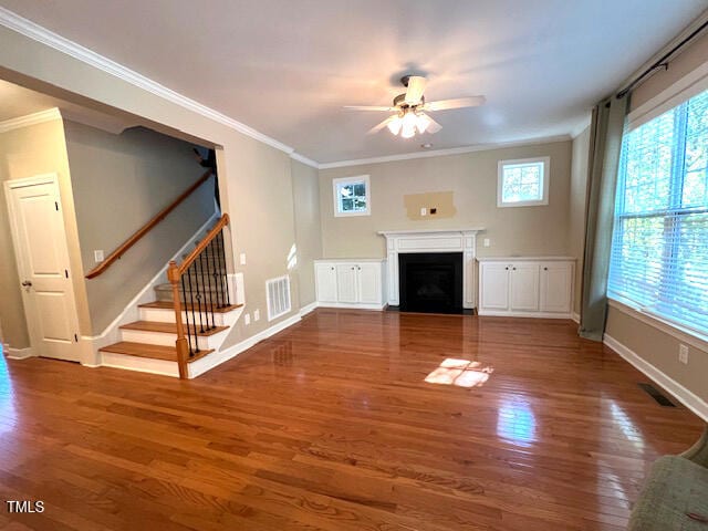 unfurnished living room with dark wood-type flooring, ceiling fan, and ornamental molding