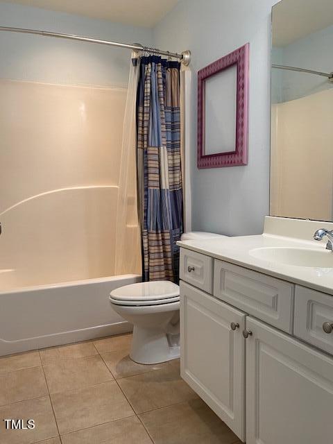 full bathroom featuring vanity, tile patterned floors, shower / bathtub combination with curtain, and toilet