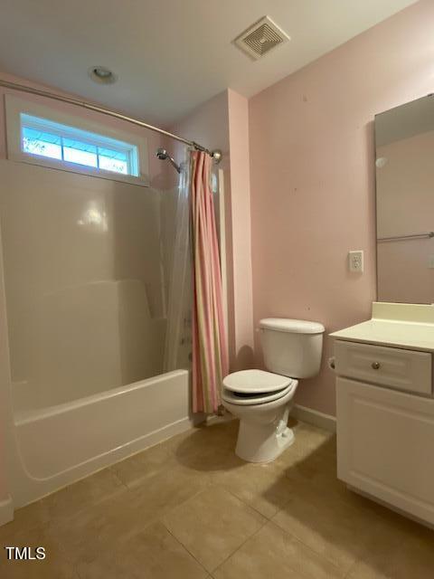 full bathroom featuring toilet, shower / tub combo, vanity, and tile patterned floors