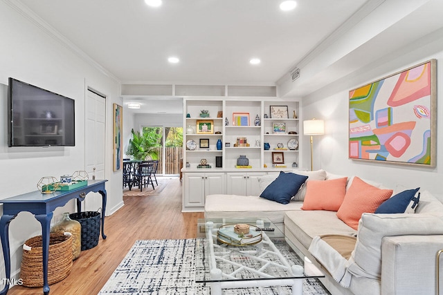 living room featuring light wood-type flooring and ornamental molding