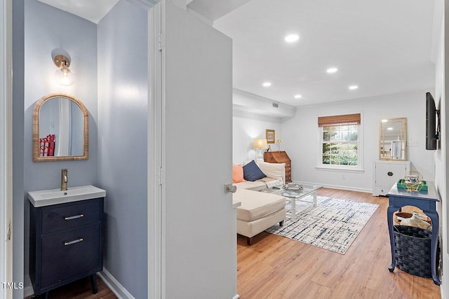 living room with hardwood / wood-style floors and sink