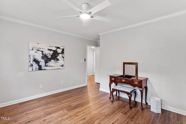 empty room with ceiling fan, ornamental molding, and light wood-type flooring