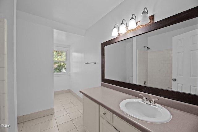 bathroom with vanity, tile patterned floors, and tiled shower