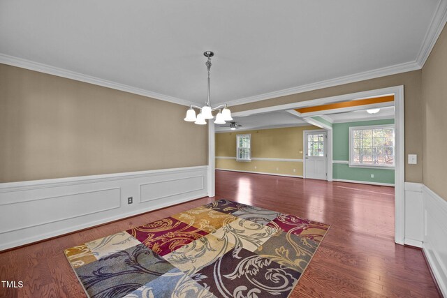 dining space featuring ornamental molding, dark hardwood / wood-style flooring, and an inviting chandelier