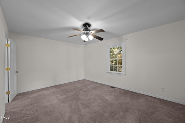 carpeted empty room featuring ceiling fan