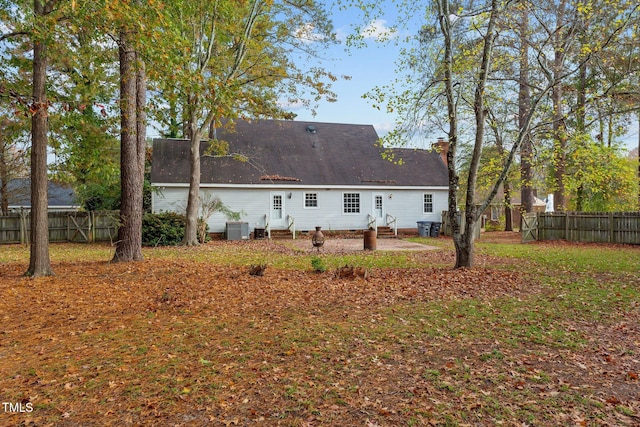 rear view of property featuring central AC