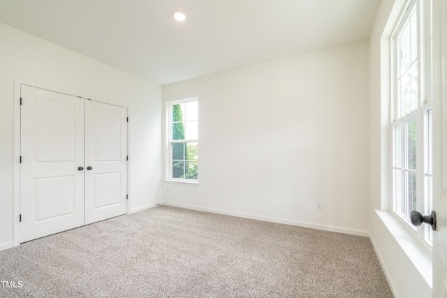 unfurnished bedroom with a closet and carpet