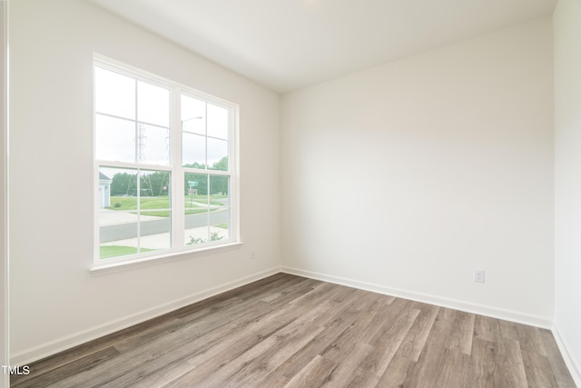 empty room with light hardwood / wood-style flooring