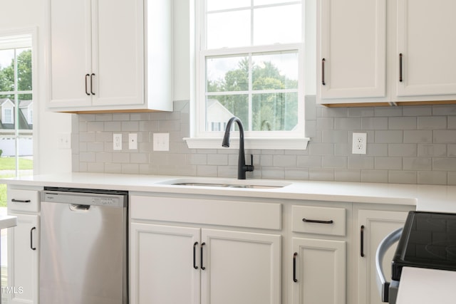 kitchen featuring dishwasher, sink, and white cabinets