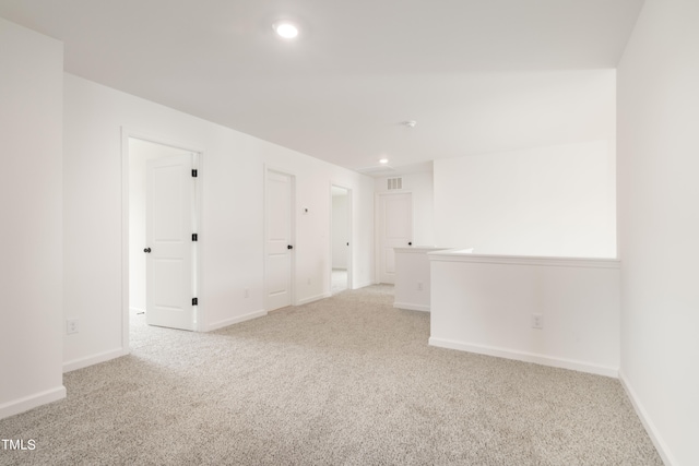 unfurnished room with light carpet