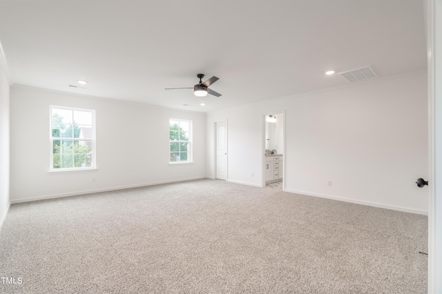 carpeted empty room featuring ceiling fan and a healthy amount of sunlight