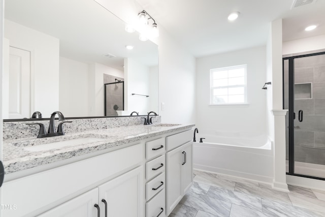 bathroom featuring vanity and independent shower and bath