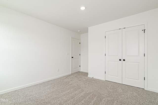 unfurnished bedroom with a closet and carpet flooring