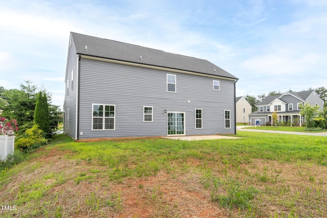 back of property featuring a patio and a yard