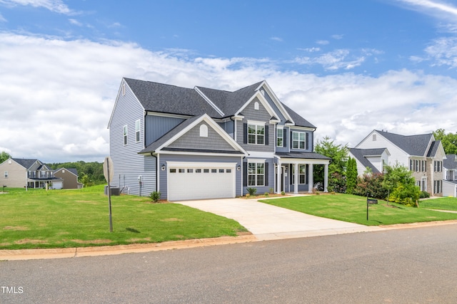 view of front of home featuring covered porch, a garage, cooling unit, and a front yard