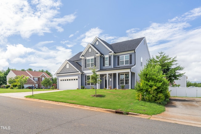 view of front of house with a garage, a front lawn, and covered porch