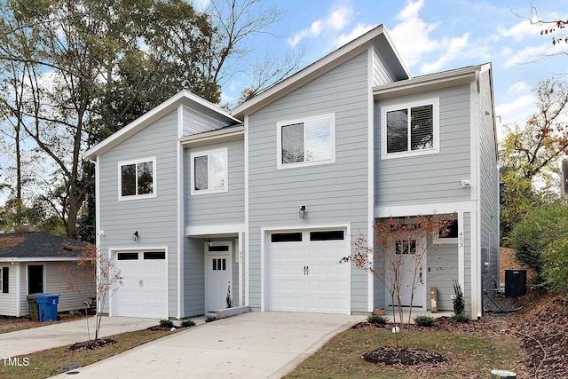 view of front of home featuring central AC unit and a garage