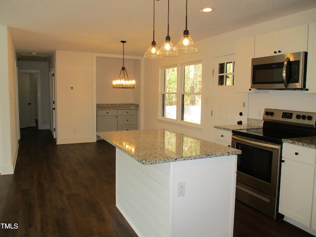 kitchen featuring stainless steel appliances, a center island, dark hardwood / wood-style floors, white cabinetry, and decorative light fixtures