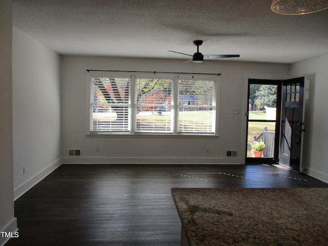 entryway featuring a textured ceiling, dark hardwood / wood-style floors, and ceiling fan