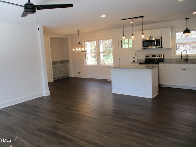 kitchen with stainless steel appliances, dark hardwood / wood-style floors, white cabinets, and sink