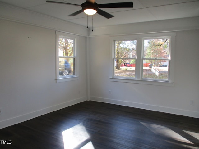 empty room featuring dark wood-type flooring and ceiling fan