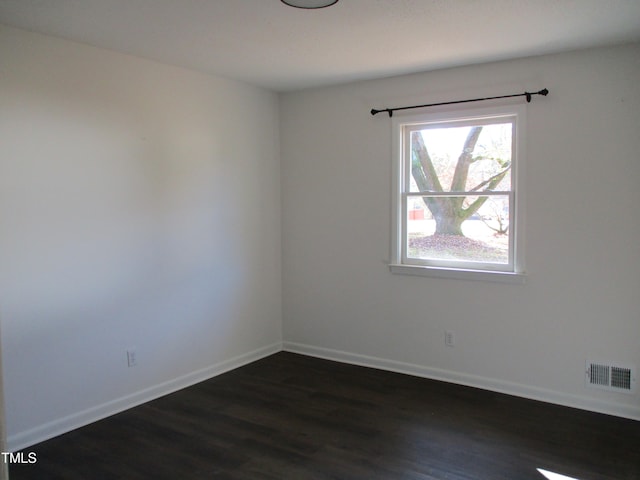 unfurnished room with dark wood-type flooring