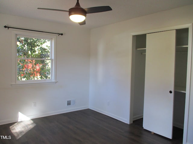 unfurnished bedroom with a closet, ceiling fan, and dark hardwood / wood-style floors