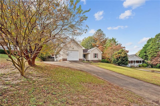 obstructed view of property with a garage and a front yard