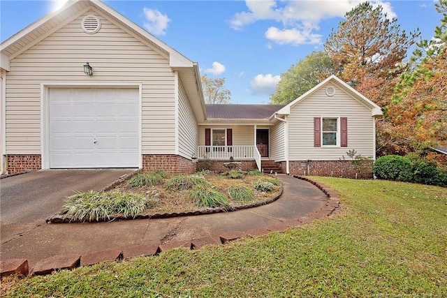 view of front of house featuring a porch, a front yard, and a garage