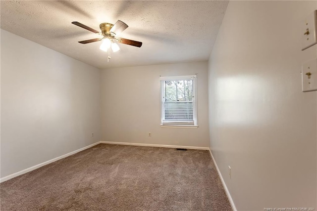 unfurnished room featuring ceiling fan, a textured ceiling, and carpet