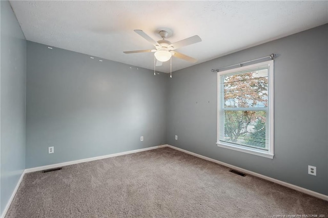 carpeted spare room with ceiling fan