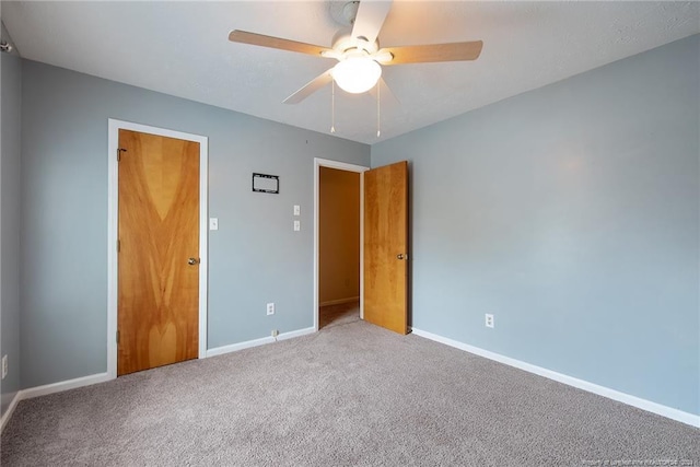 unfurnished bedroom featuring ceiling fan, carpet flooring, and a closet