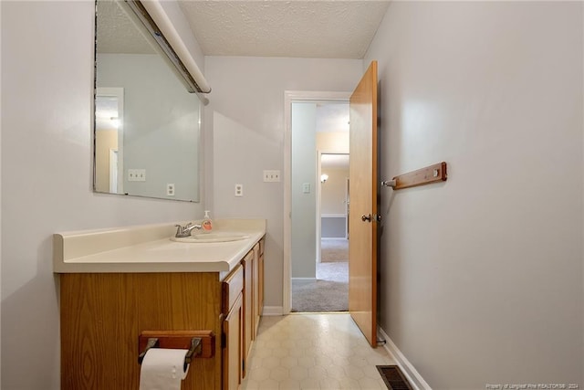 bathroom featuring vanity and a textured ceiling