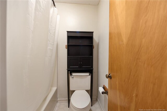 bathroom with toilet and tile patterned floors