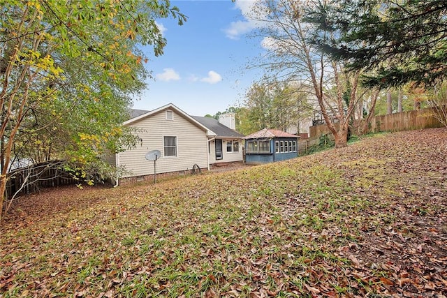 back of property featuring a sunroom