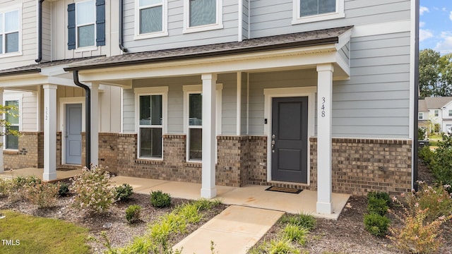 property entrance with covered porch