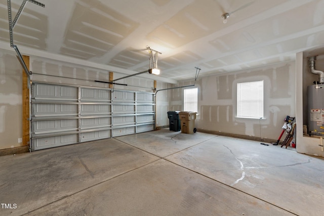 garage featuring a garage door opener and water heater