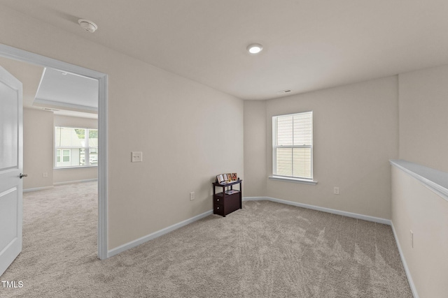 unfurnished room with light carpet