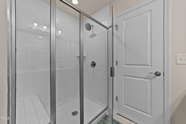 bathroom with a shower with shower door