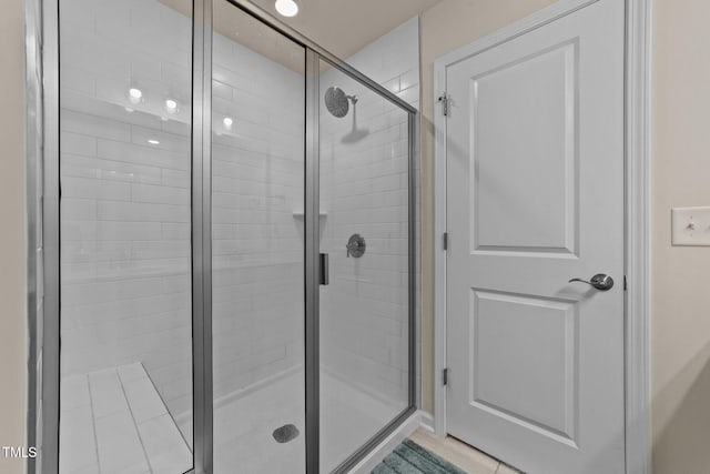 bathroom featuring a shower with door