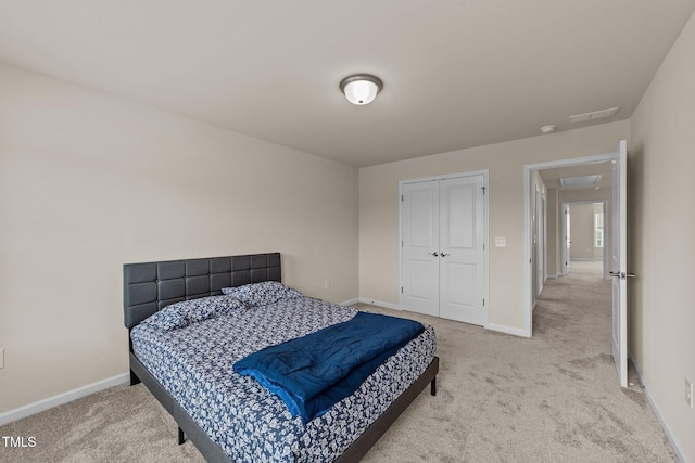 bedroom with a closet and light carpet