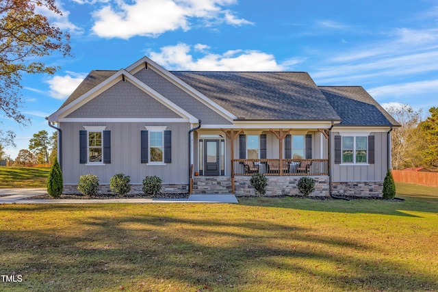 view of front of property with a porch and a front lawn