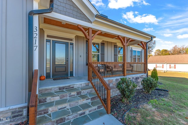 view of exterior entry with a porch