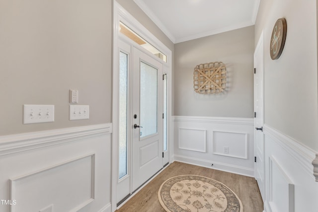 entrance foyer with light wood-type flooring, plenty of natural light, and crown molding